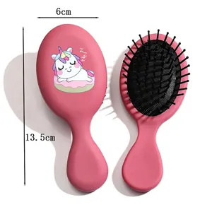 Mini pink hairbrush for girls featuring a cute unicorn graphic and massage air cushion