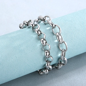 Polished silver titanium steel chain bracelet with oval links on a blue pedestal