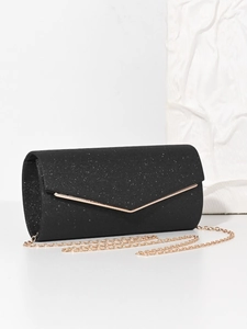 Detail of black sequined envelope evening bag with elegant golden chain strap