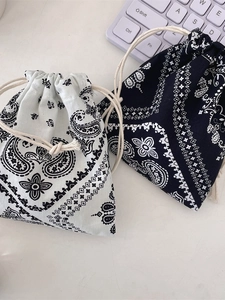 Set of two paisley drawstring pouches in black and blue for jewelry storage and organizing