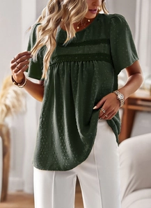 Detail of green round neck top featuring lace patchwork and jacquard dot fabric textures