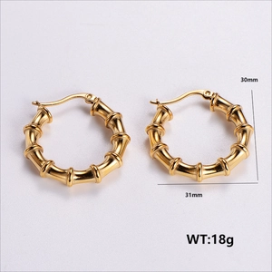 Macro view of gold-plated bamboo texture hoop earrings with size and weight specs