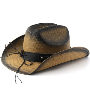 Macro detail of the woven straw texture and leather band with bronze studs on cowboy hat