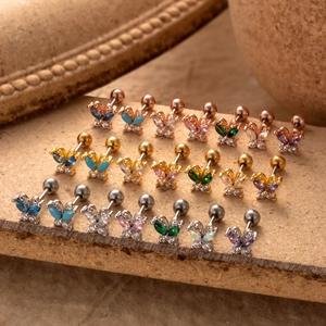 Macro shot of colorful zircon butterfly stud earrings in gold silver and rose gold finishes