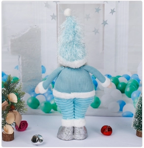 Back view of light blue knitted Christmas gnome with plush hat and silver shoes