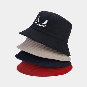 Detailed stack of four cotton bucket hats featuring ghost face embroidery in multiple colors