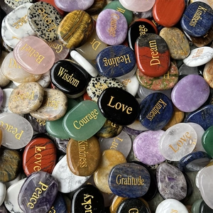 Polished oval natural crystal stones with engraved golden inspirational words