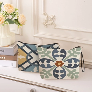 Bohemian geometric makeup bags with zippers and wristlets in a cozy home setting