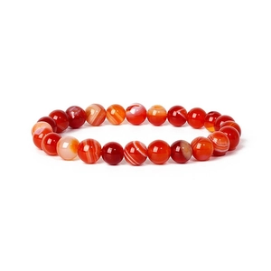 Macro detail of natural red agate beads showing unique banded textures and polished finish