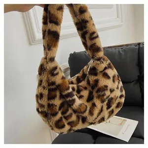 Detail of plush leopard print faux fur handbag with thick texture and metal zipper closure