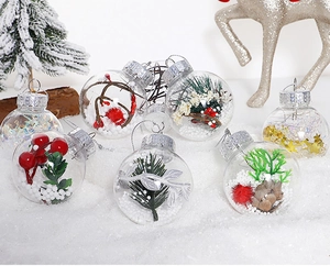 Detail of 6cm clear PET Christmas ornaments with faux snow, pine needles and berries