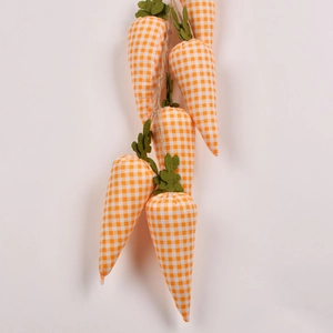 Detail of five fabric Easter carrots with orange plaid and green felt leaves on twine
