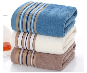 Detailed macro view of soft striped cotton towels in blue, white, and brown colors