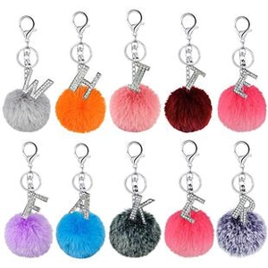 Detail of colorful faux fur pompom keychains with rhinestone initial letter pendants