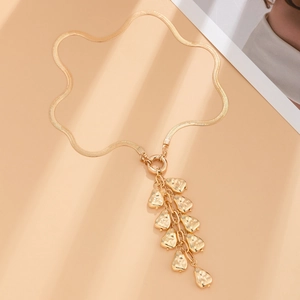 Detailed flat lay of golden snake chain necklace with baroque metal fringe pendants