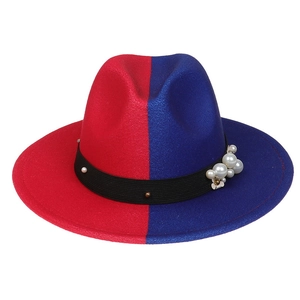 Detail of red and blue wool fedora hat featuring a black pearl and rivet ribbon band