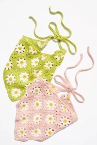 Close-up of handmade crochet daisy bandanas in green and pink with floral details