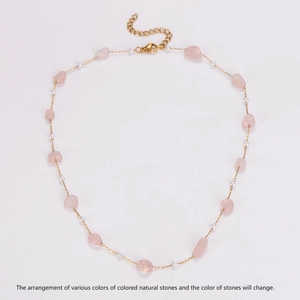 Detail of gold chain necklace with pink natural stones, white pearls and lobster clasp