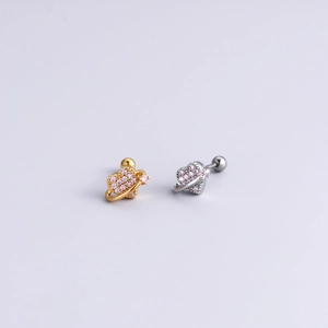 Detailed shot of gold and silver heart studs with pink zircon and screw-back design