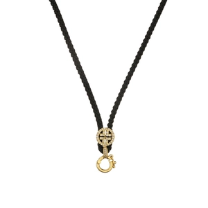 Detail of black braided necklace cord with gold-plated lobster clasp and cross pendant