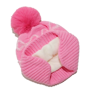 Detail of pink knit hat with soft white fleece lining and large faux fur pompom ball