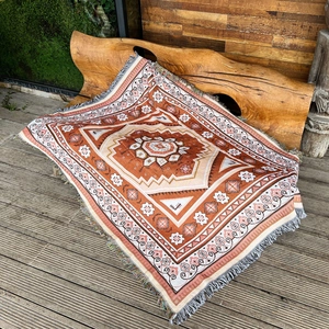 Bohemian reddish-brown cotton woven throw blanket with geometric patterns and tassels