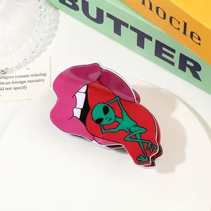 Macro detail of pop art acrylic shark clip with pink lips and green alien design