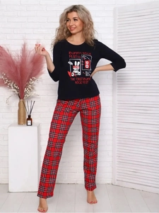 Detail of women's Christmas pajama set with bunny graphic top and red plaid trousers