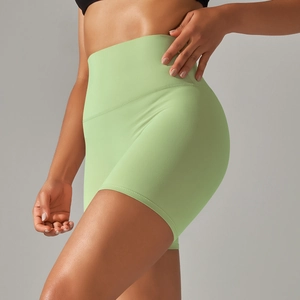 Close-up of mint green high-waisted yoga shorts with soft matte brushed fabric texture