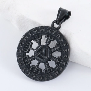 Close-up of black Viking Vegvisir compass pendant with Futhark runes on white stone