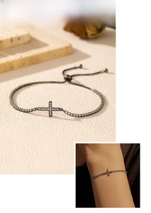 Macro view of gunmetal cross bracelet with micro-paved crystals and adjustable chain