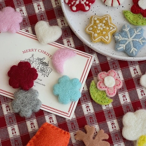 Close-up of colorful Christmas wool felt accessories including hearts and flowers