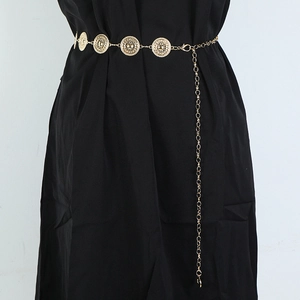 Detailed view of women's gold metal waist chain with circular hollow decorative plates