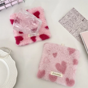 Pink plush heart pattern coaster made of soft faux fur for stylish home table decor