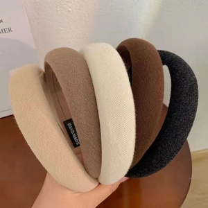 Detail of assorted wide sponge headbands with handmade label and knit texture