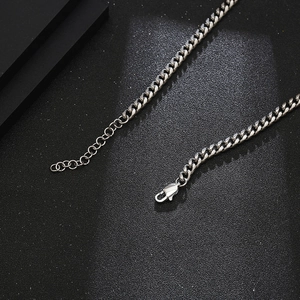 Detailed close-up of silver Cuban chain necklace with adjustable lobster clasp and extension