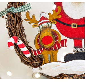Macro detail of natural rattan wreath with hand-painted wooden reindeer and Santa decor