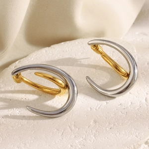Two-tone 18K gold plated stainless steel curved hook earrings on a white stone base