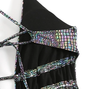 Macro shot of holographic crocodile texture and crisscross straps on swimsuit