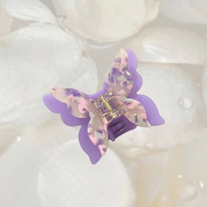 Detail view of double-layered acetate butterfly hair claw with purple marble texture pattern