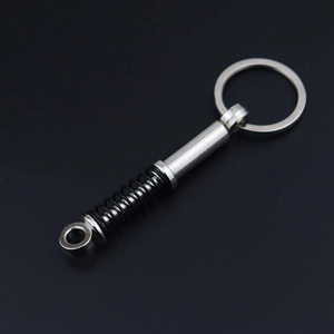 Detailed view of creative metal shock absorber keychain with black spring and silver finish
