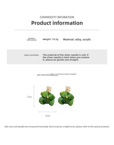 Detail view of green acrylic flower earrings with golden texture and 19.3g weight