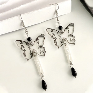 Detail view of butterfly drop earrings with Chinese calligraphy patterns and beads