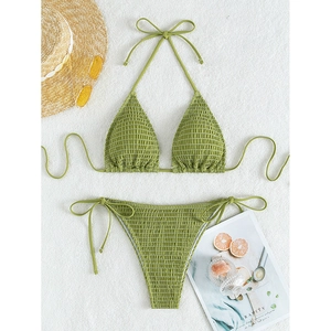 Grass green ruched halter bikini set with side tie high waist bottom on white plush background