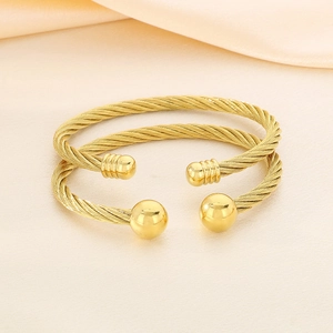 Elegant 18K gold plated stainless steel twisted cable cuff bracelet set on beige silk