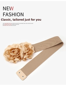 Detail of champagne elastic cinch belt with dual fabric flower accents and metal snap button