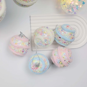 Detailed view of 6cm pink and blue swirl Christmas foam ball ornaments with silver sequins
