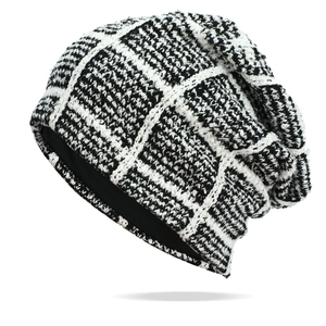 Black and white checkered knit beanie hat with slouchy texture for winter warmth