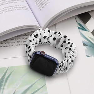 Close-up of black and white polka dot scrunchie band for Apple Watch with fabric texture