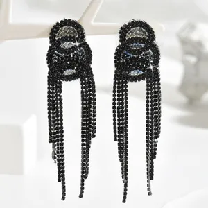 Macro detail of long black rhinestone tassel earrings showing intricate crystal fringe